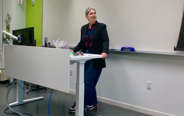 Harvard SEAS GSD professor Karen Korellis Reuther speaking at a white desk